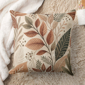 Coussin de jet botanique terreux à motif de feuill