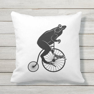 Coussin D'extérieur Grenouille ou crapaud noire et blanche sur un vélo