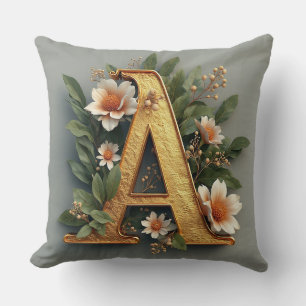 Coussin Lettre A dorée entourée d'arrangements floraux