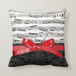 Coussin Notes de musique et ruban de rouge de faux