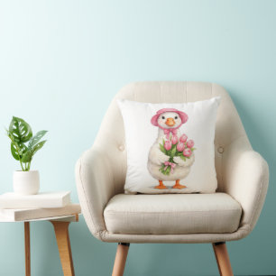 Coussin Oie blanche tenant un bouquet de tulipes roses