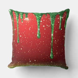 Coussin Pailletage vert qui coule sur fond rouge