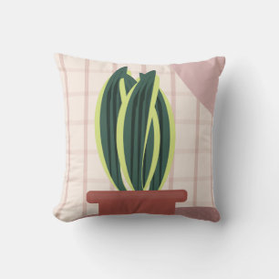 Coussin Plantes serpent sur fond rose à carreaux