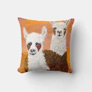 Coussin Souriant, lamas curieuses contre le ciel d'or