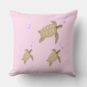 Coussin Tortues de mer nageant sur or rose