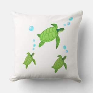 Coussin Tortues de mer vertes nageant sur fond blanc