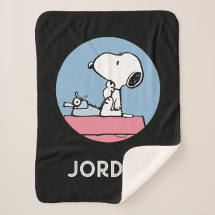 Couverture Sherpa cacahuètes Snoopy à la machine à écrire