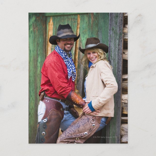 Cowboy and cowgirl holding hands in front of an postcard (Front)