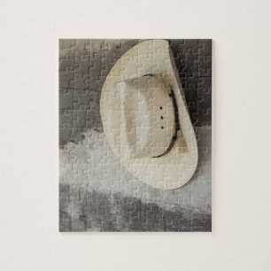Cowboy hat hanging on wall of log cabin jigsaw puzzle
