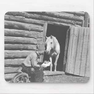 Cowboy reading a letter with a horse mouse pad