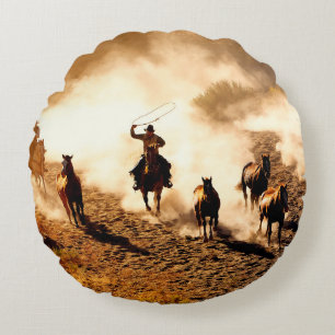 Cowboys chasing wilding horses. roping and riding, round pillow