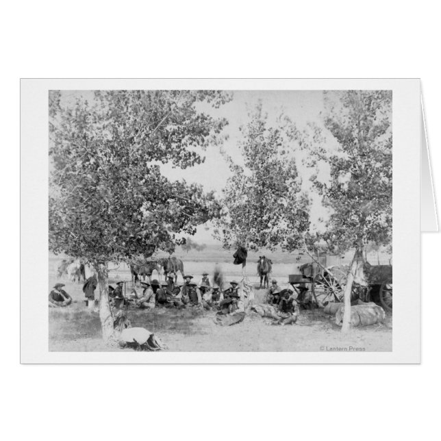 Cowboys Eating Dinner on Ground Under Trees (Front Horizontal)