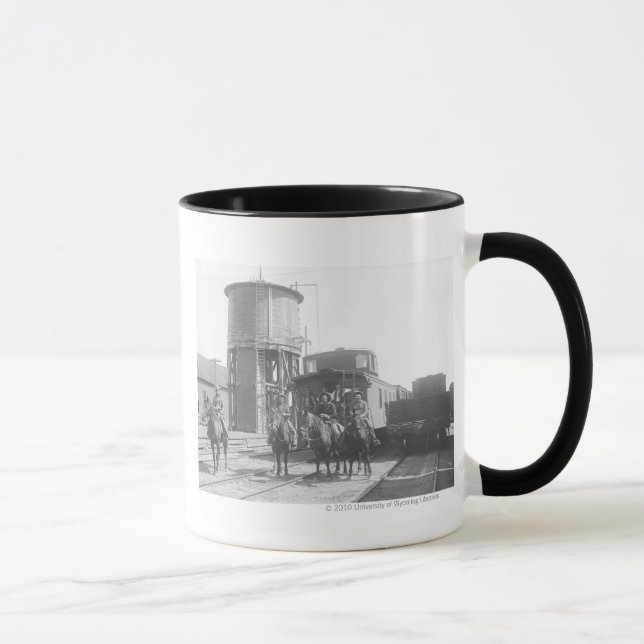 Cowboys on horses posing in front of a train mug (Right)