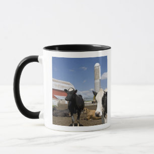 Cows in front of a red barn and silo on a farm mug
