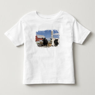 Cows in front of a red barn and silo on a farm toddler t-shirt