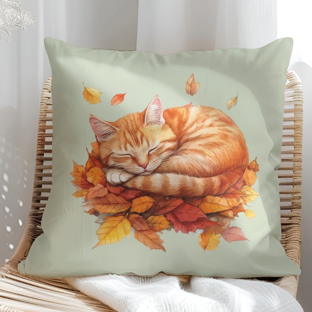 Cozy Sleeping Ginger Cat Sage Green Pillow  (Cozy Sleeping Ginger Cat Terracotta Pillow in a sunny boho rattan chair.)