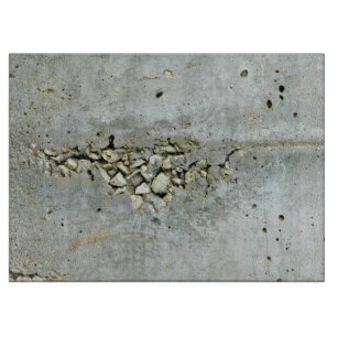 Cracked concrete wall with small stones cutting board