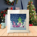 Crafty Snowman Knitting Scarf Tote Bag<br><div class="desc">Vector illustration of two adorable cartoon snowmen dressed in knitted hats and scarves. The big crafty snowman is knitting an oversized scarf for the little one. The scarf is already wrapped several times around the cute little snowman.</div>