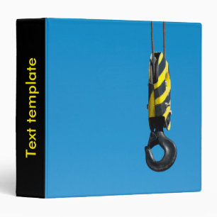 Crane hook with yellow and black stripes hanging binder