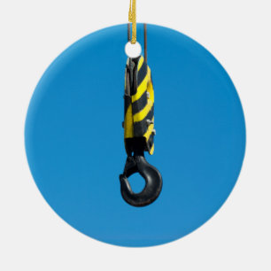 Crane hook with yellow and black stripes hanging ceramic ornament
