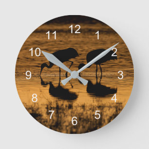 Cranes Silhouetted by the Sunset Round Clock