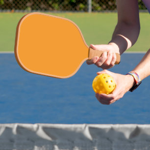 Create Stunning Visuals with Orange Background Pickleball Paddle