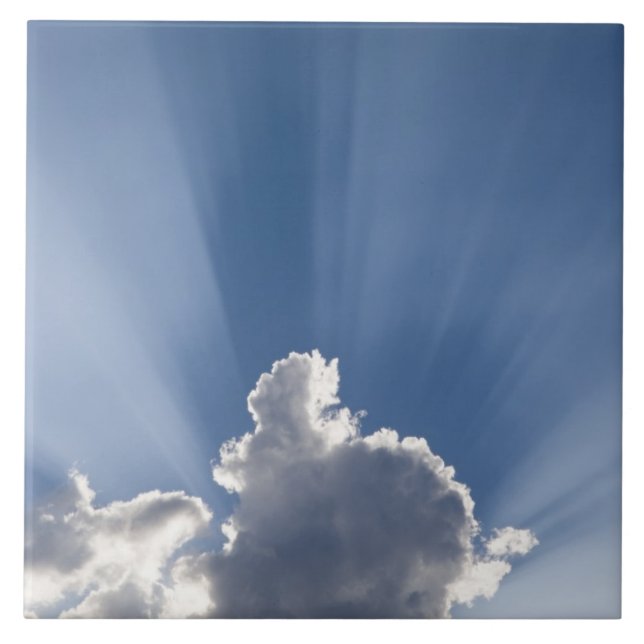 Crepuscular or God's rays streak past cloud. Tile (Front)