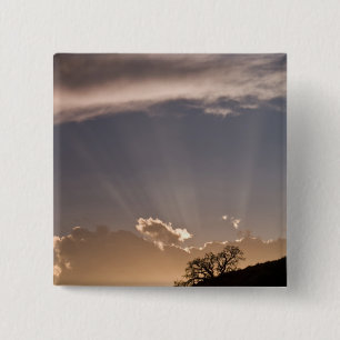 Crepuscular rays radiate across the sky at 2 inch square button