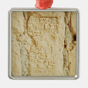 Cuneiform script on a palace wall metal ornament
