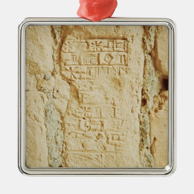 Cuneiform script on a palace wall metal ornament (Front)