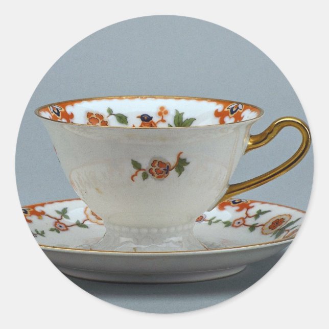Cup and saucer with colourful flowers on it. classic round sticker (Front)