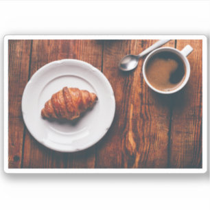 Cup of Coffee And Croissant on Rustic Table
