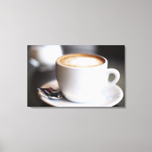 cup of coffee latte on table, close-up canvas print