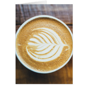 Cup of Coffee Latte with Leaf-Shape Foam on Wood