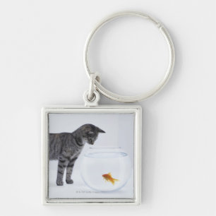 Curious cat watching goldfish in fishbowl keychain
