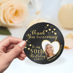 Custom Black and Gold 50th Birthday Thank You Classic Round Sticker<br><div class="desc">For improved design please visit this page: https://www.zazzle.com/custom_black_and_gold_50th_birthday_thank_you_classic_round_sticker-256449795787557408 == Create unique black and gold Thank You stickers for the 50th birthday party favours with an elegant design that features a photo in a heart shape, name, and the fiftieth milestone. On this design, black background imitates metallic surface. Use the template...</div>