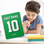 Custom Green Last Name Sports Jersey Number  Notebook<br><div class="desc">Name,  number and drop shadow are customizable so you can make a sporty looking yet useful notebook unique and matching to your favourite sport team colours or room decor. Green background.</div>