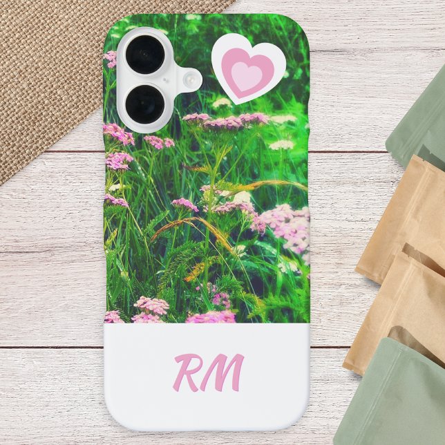 Custom Monogram Floral Meadow Pink White iPhone 16 Case (A phone case with monogram initials in pink on white, flowers and grass photo and cute hearts)