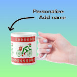 Custom name christmas cyclists coffee mug<br><div class="desc">There are three christmas cyclists on this mug - in pictogram form, green, and wearing festive hats and boots. They are each carrying a special christmas parcel on their bicycles. Above and below is a red stripe with a pattern of stylized poinsettia flowers in matching christmas colours of green, white...</div>