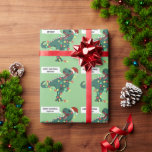 Custom Name Dinosaur Merry Christmas Lights Kids Wrapping Paper<br><div class="desc">Make their Christmas presents even more special with this personalized gift wrap,  featuring a cartoon T-Rex wearing a Santa hat and tangled up in Christmas lights on a light green background. A cartoon speech bubble contains the words "Merry Christmas" and your child's name.</div>
