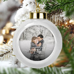 Custom Photo First Christmas Engaged White Script Ceramic Ball Christmas Ornament<br><div class="desc">Commemorate your engagement with this beautiful modern keepsake ornament. The white text reads "Our first Christmas engaged, " with the word "engaged" in elegant handwriting script with flourishes before and after. Replace the sample image with your favourite photo, and add your names and the year. A black gradient filter helps...</div>