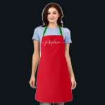 Custom Red Christmas Simple Elegant script Name Apron<br><div class="desc">Do you know someone who would love a personalized apron as she bakes those goodies, cooks delicious dishes in holiday colours (red and green). A perfect gift to encourage her talents on the holidays. Black script for the name with long-tail embellishments. Pro tip: keep the little square for the long-tailed...</div>