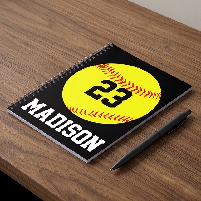 Custom Softball Notebook (Personalized softball notebook with custom name and number on a desk.)