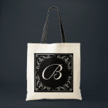 Custom vintage monogram letter wedding tote bag<br><div class="desc">Custom vintage monogram letter wedding wedding tote bag with swirls. Classy black and white retro design with elegant script typography and swirly corners. Personalize with name or monogram of bride, bridesmaid, maid of honour, mother of the bride, flower girl etc. Also perfect for classic wedding favours. Stylish monogrammed wedding logo...</div>