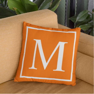 Customize monogram on bright orange throw pillow