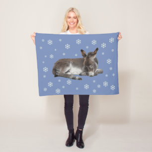 Cute baby donkey with snowflakes on blue fleece blanket