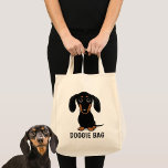 Cute Black and Tan Dachshund Wiener Dog Doggie Tote Bag<br><div class="desc">An adorable smooth coated black and tan Dachshund puppy looking up. The text "Doggie Bag" can be personalized with your own name or slogan. A cute wiener dog lover’s tote bag, great for shopping for groceries or pet supplies. This fun weenie dog cartoon reusable bag makes a perfect gift for...</div>