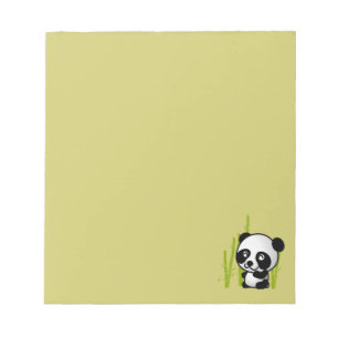 Cute black and white panda bear in a bamboo grove. notepad