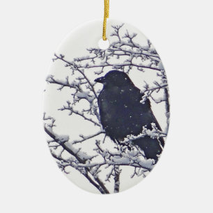 Cute black bird in snowy branches ceramic ornament