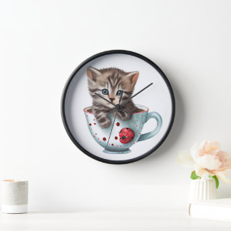CUTE BROWN TABBY KITTEN SITTING IN A RED WHITE CUP CLOCK